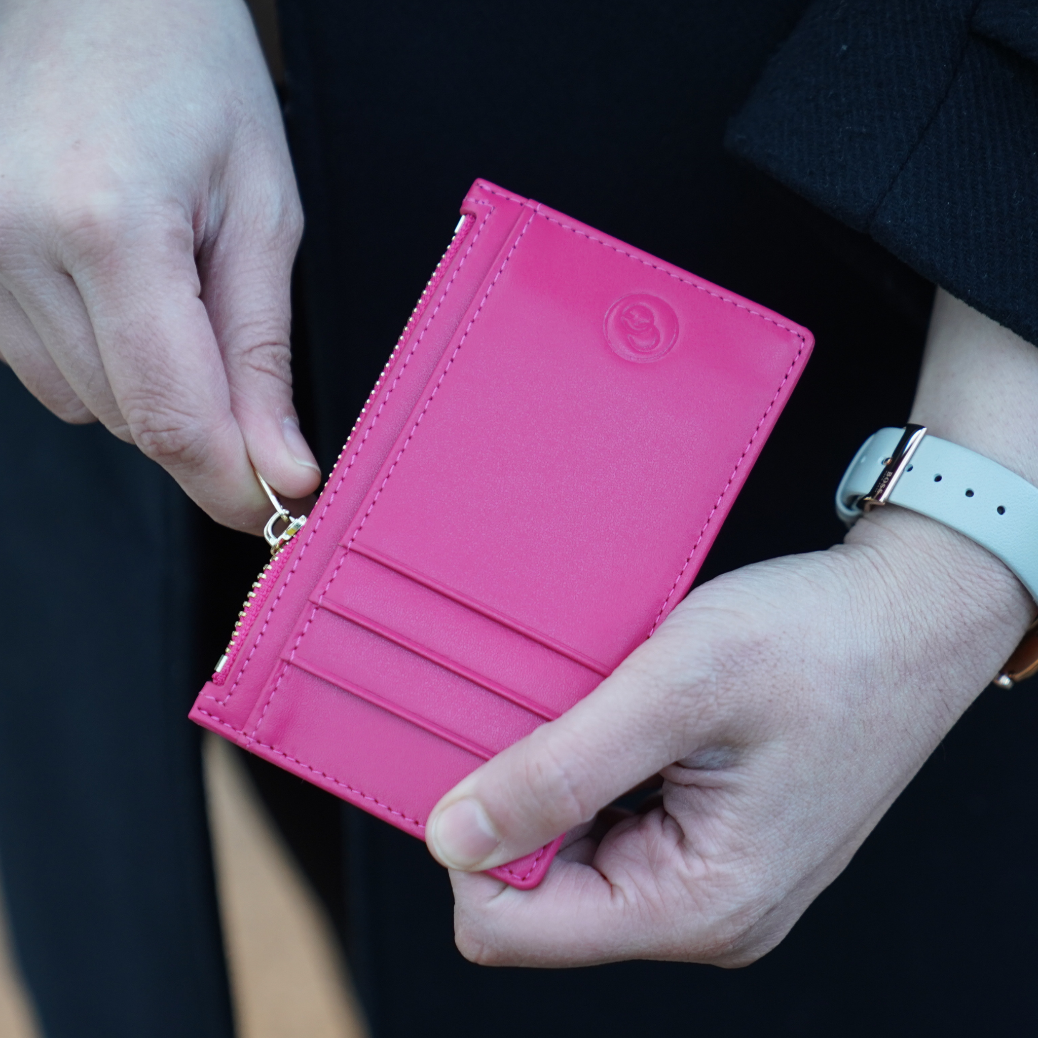 small coin purse with card slots in womans hand